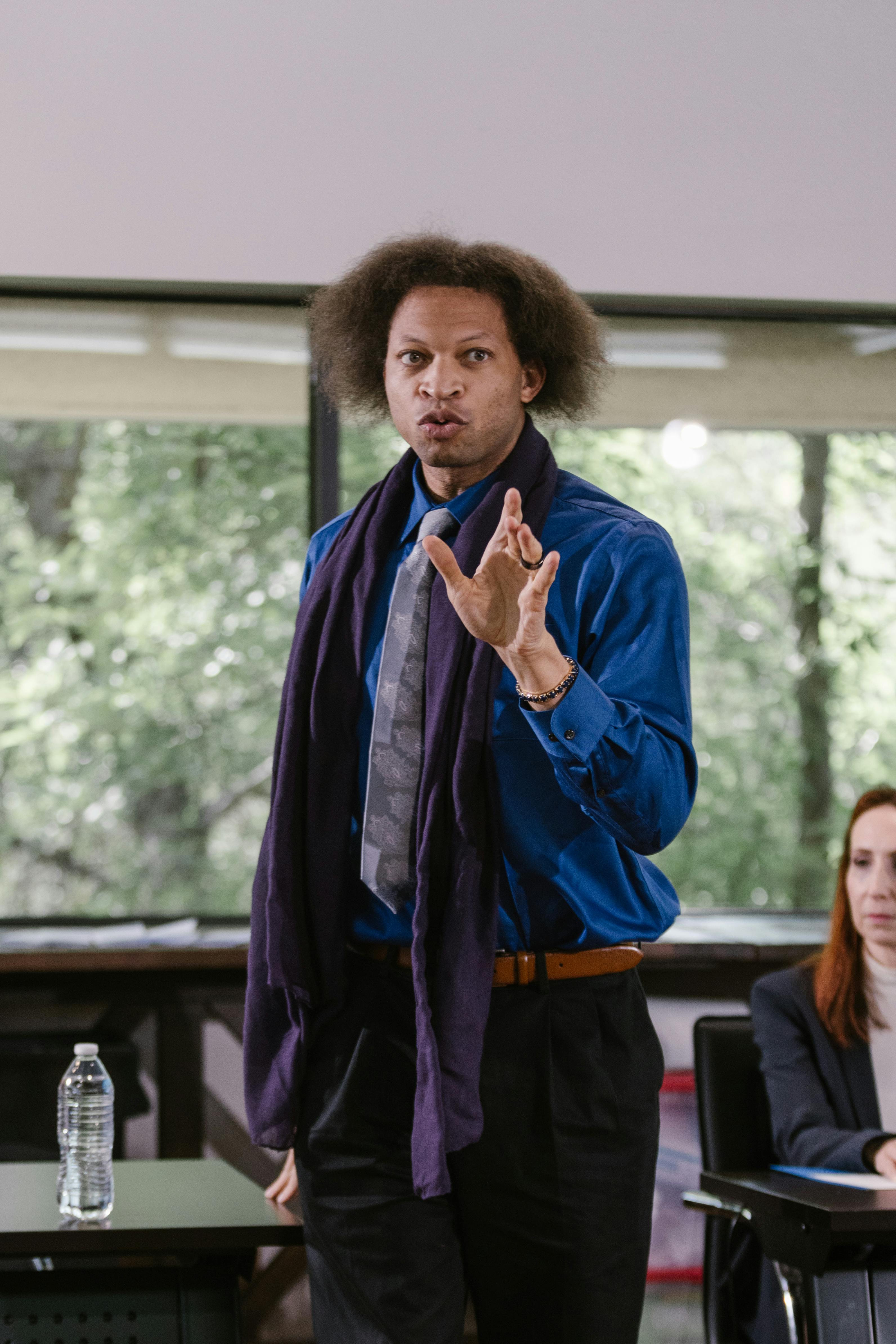 Marcus Cole presenting to an engaged audience at a leadership conference